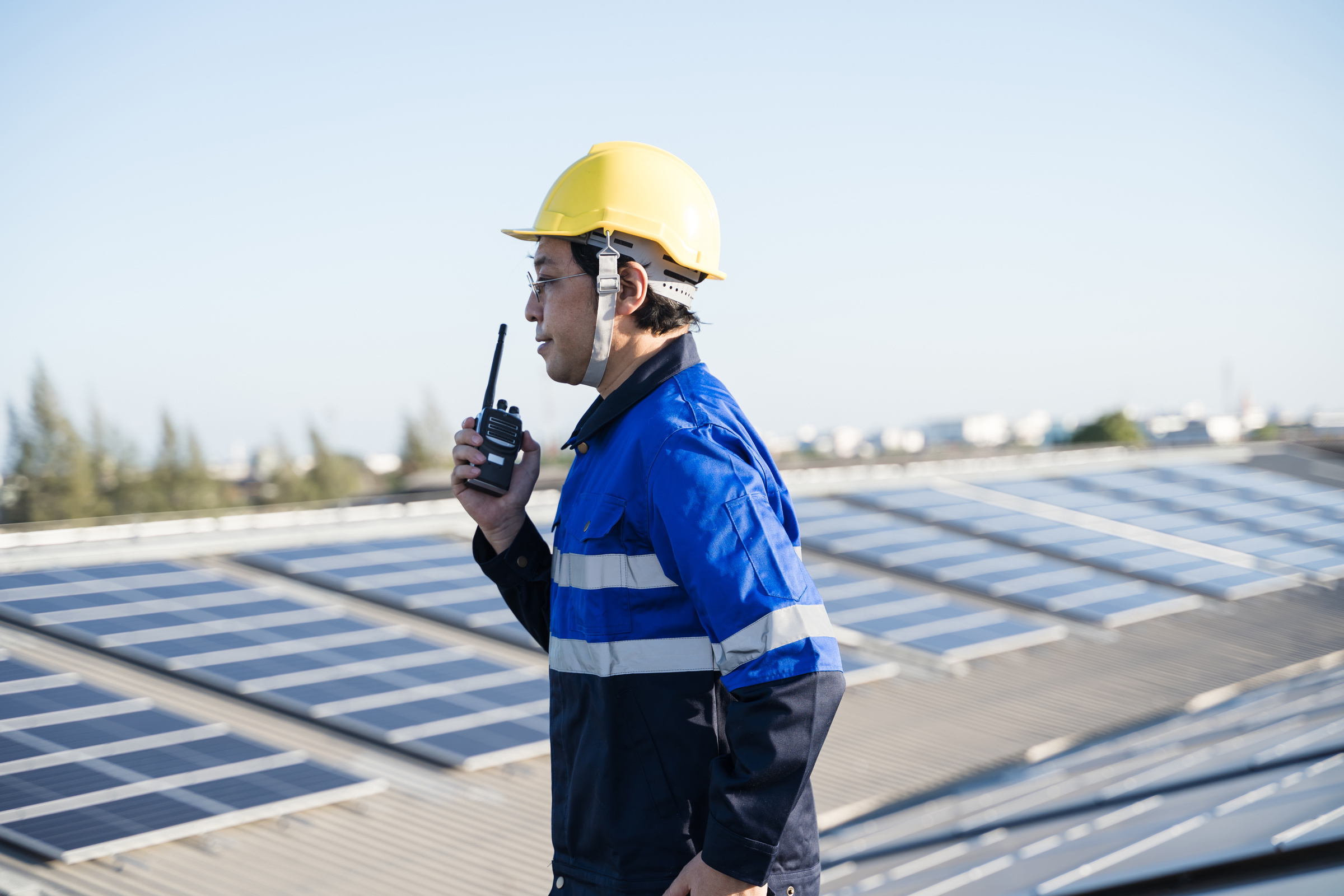 Engineer on Rooftop with Solar Panels